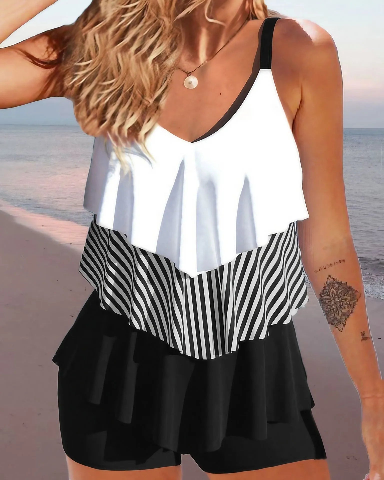 Women's sleeveless backless spaghetti strap bikini swimsuit with ruffle detail and split briefs.