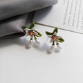 Women's alloy earrings set showing flower studs and camellia ear clip in contrasting colours