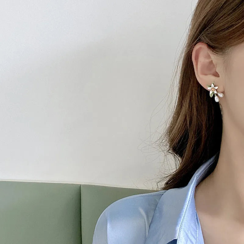 Women's alloy earrings set showing flower studs and camellia ear clip in contrasting colours