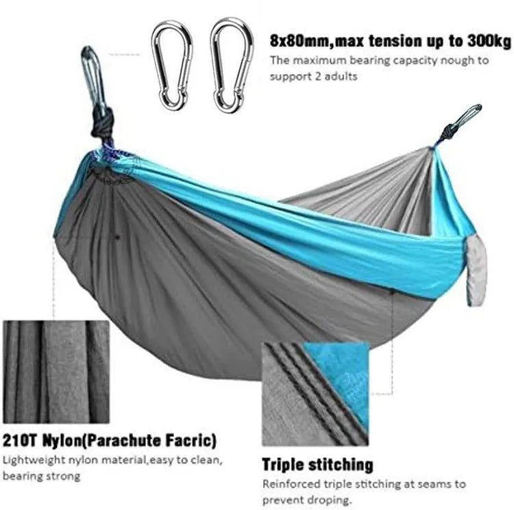 Blue and grey parachute nylon outdoor hammock hung between trees, showing its spacious 270cm length.