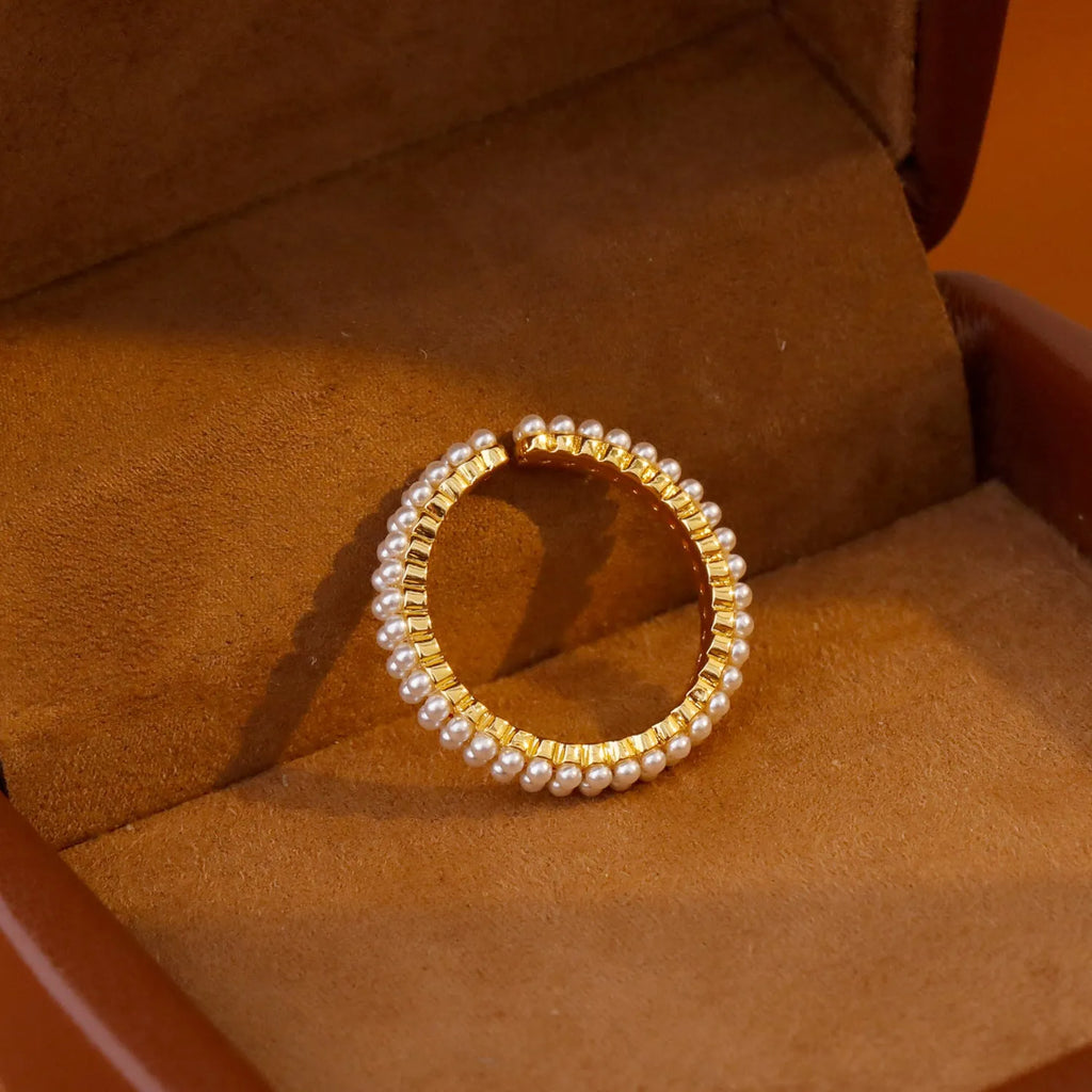 Gold geometric open mouth women's ring with round pearl-like elements on copper base