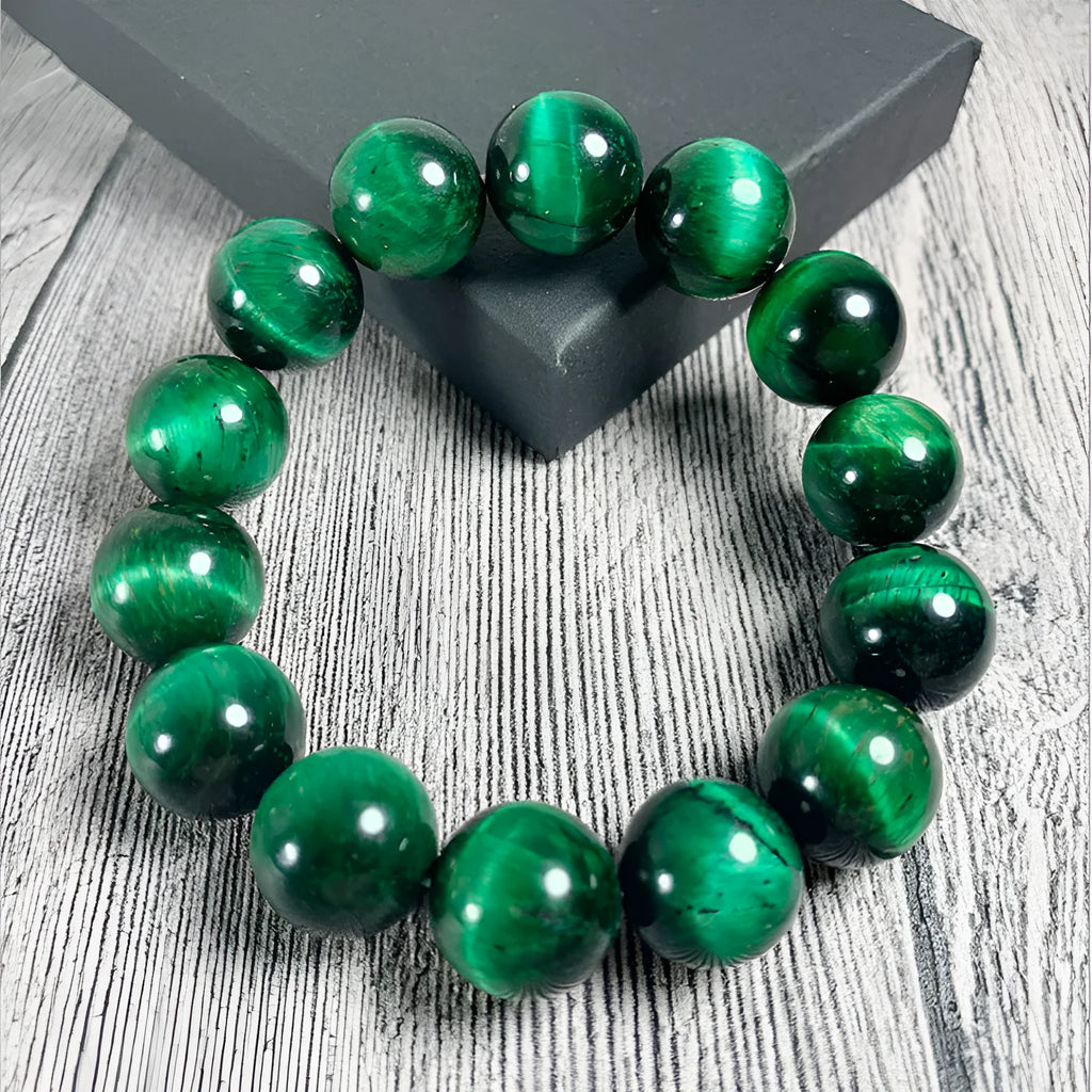 Green tiger eye stone bracelet with geometric beads in various sizes on wrist