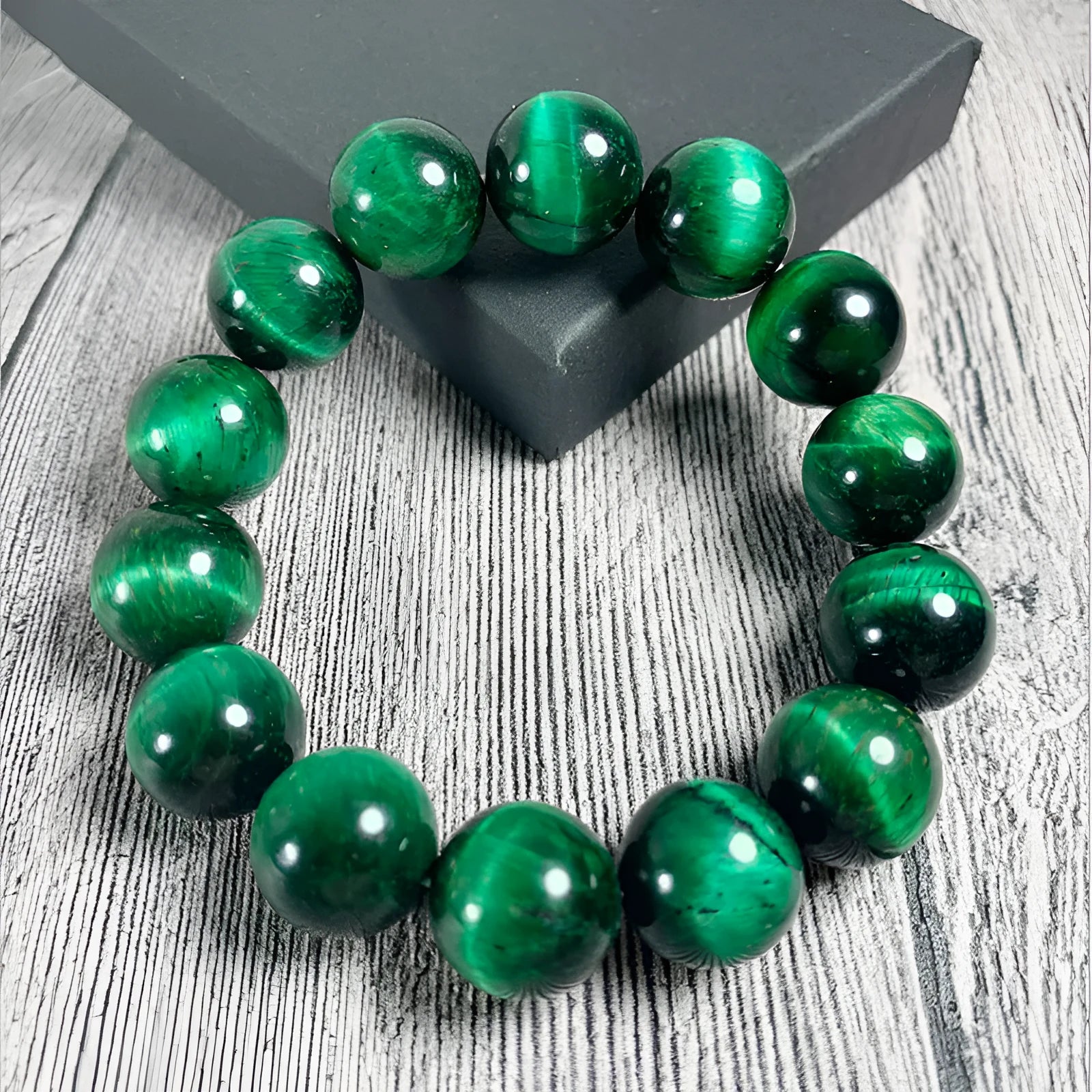 Green tiger eye stone bracelet with geometric beads in various sizes on wrist