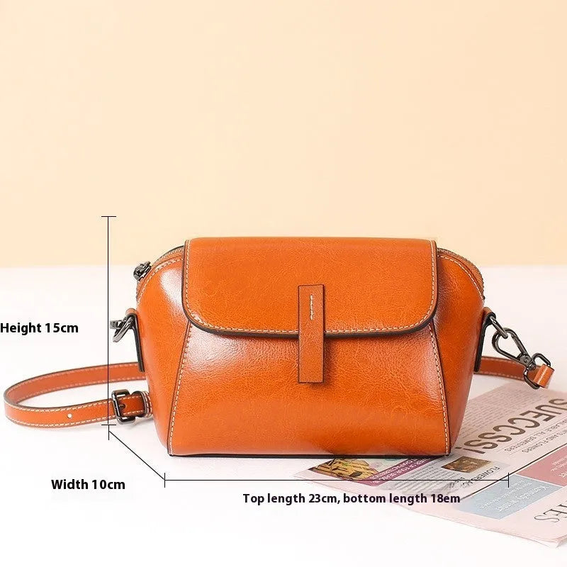 Brown genuine oil wax leather women's messenger bag with shell shape and single cross-body strap