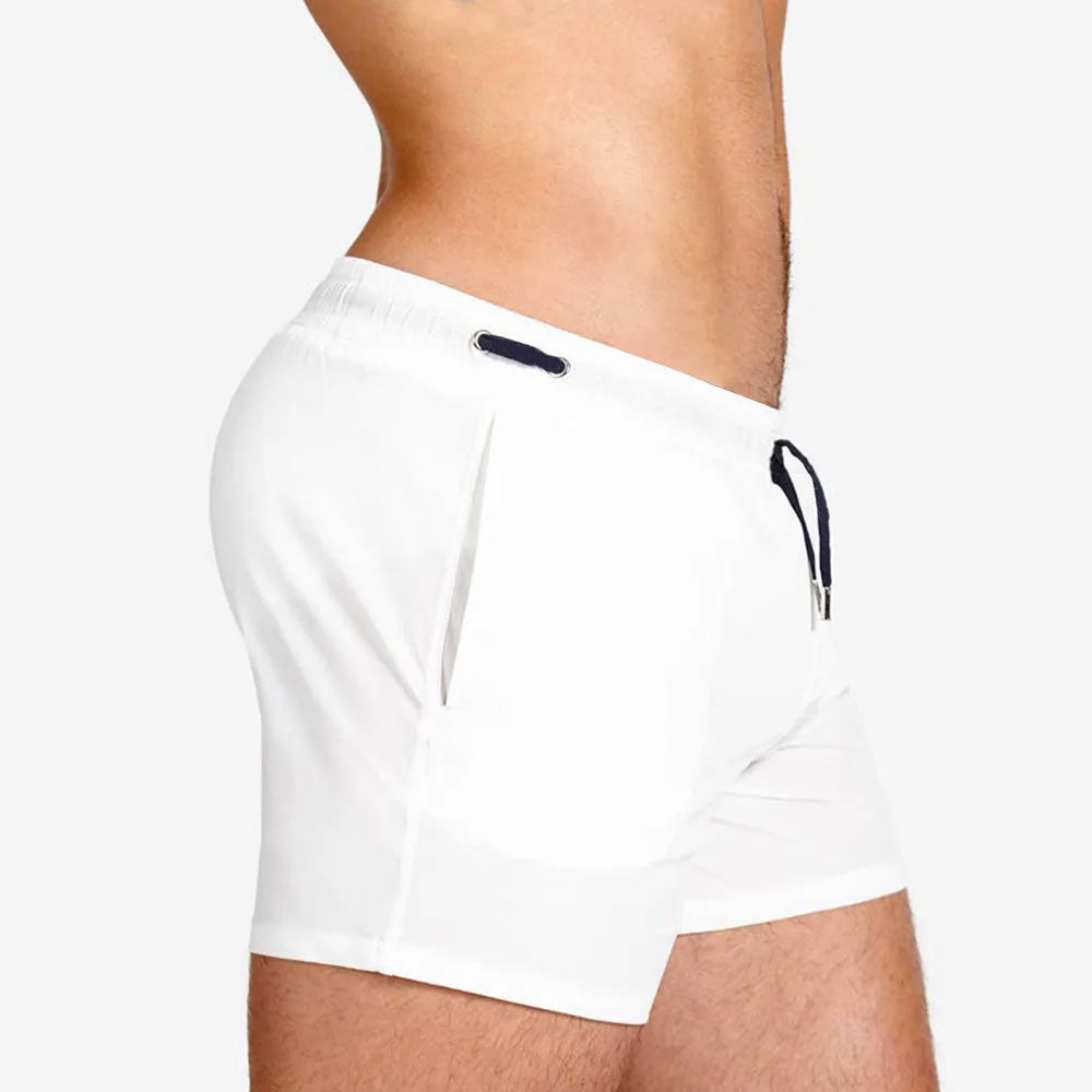 Men's solid colour polyester swimming shorts with mesh lining shown in multiple colours