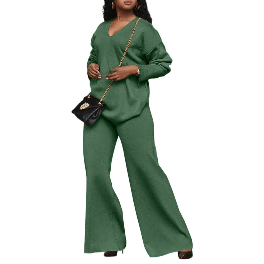 Women's brown suede two-piece suit with split sleeve top and matching trousers laid flat