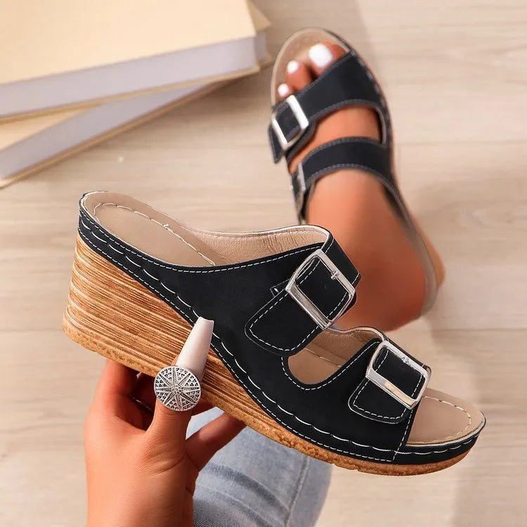 Women's creamy white beach slippers with a silver buckle on the strap