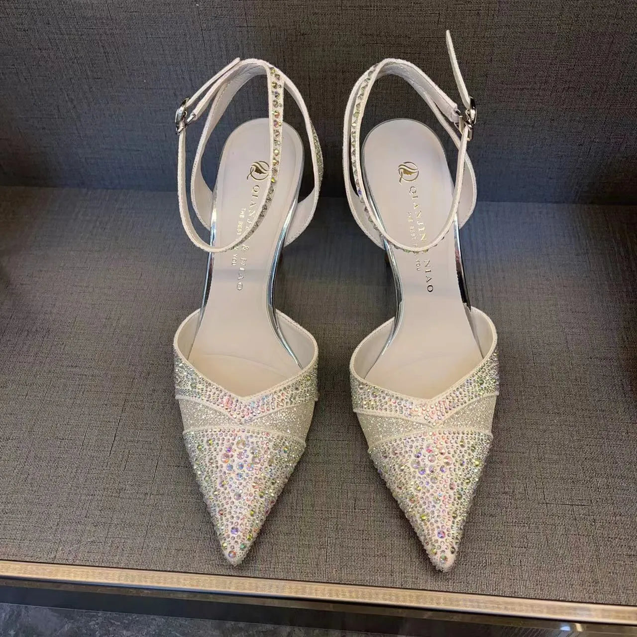 Women's silver and black hollow high heels with red sole and pointed stiletto heel