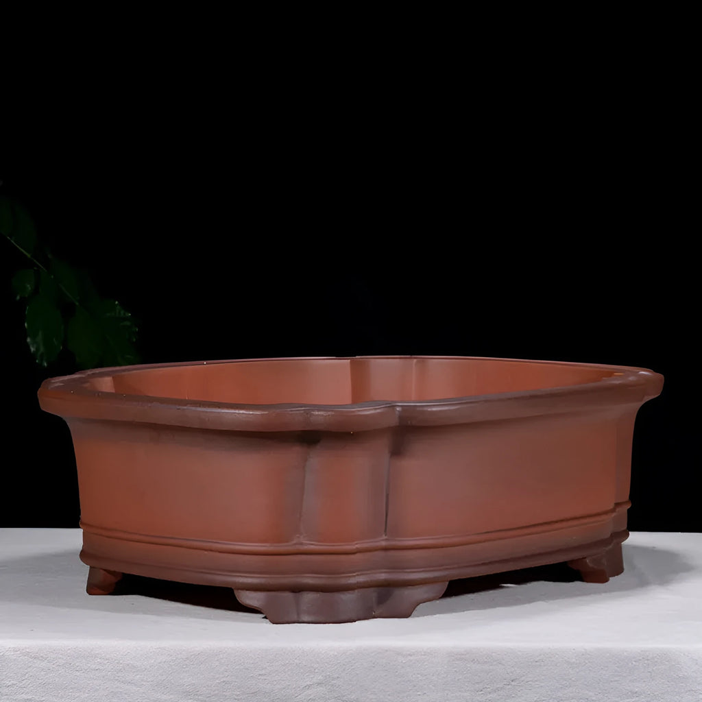 Large antique-finish purple clay flowerpot with raised tree stump and floral design.
