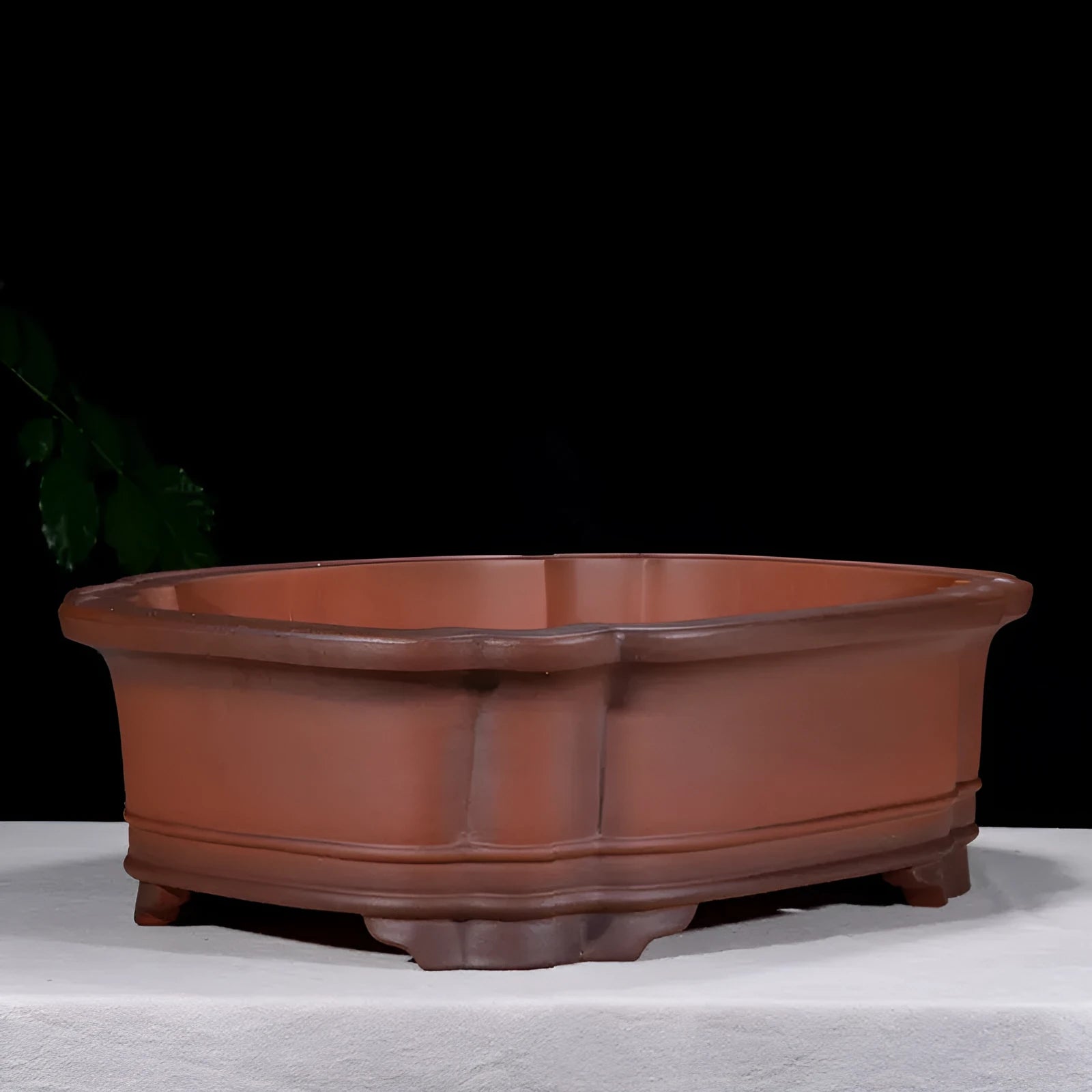 Large antique-finish purple clay flowerpot with raised tree stump and floral design.