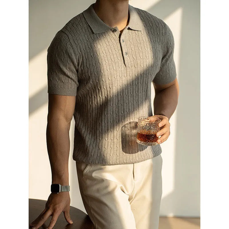 Men's khaki short sleeve business top on a hanger.