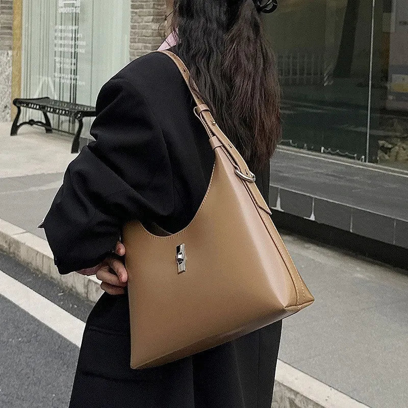 Women's genuine leather dumpling-shaped crossbody shoulder bag in apricot colour with a sandwich pocket.