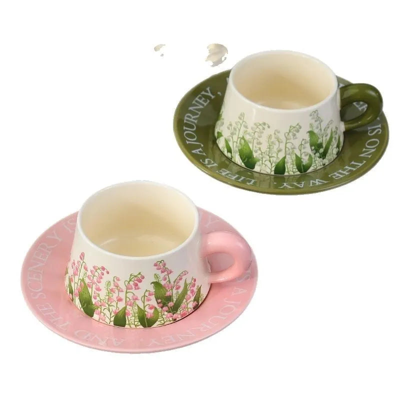 Ceramic coffee cup and saucer set for couples with stirring spoons in two pattern choices.