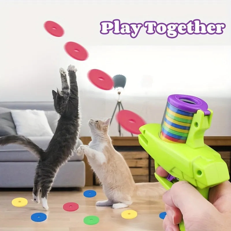 Interactive cat toy launcher in green or purple with foam discs for indoor play