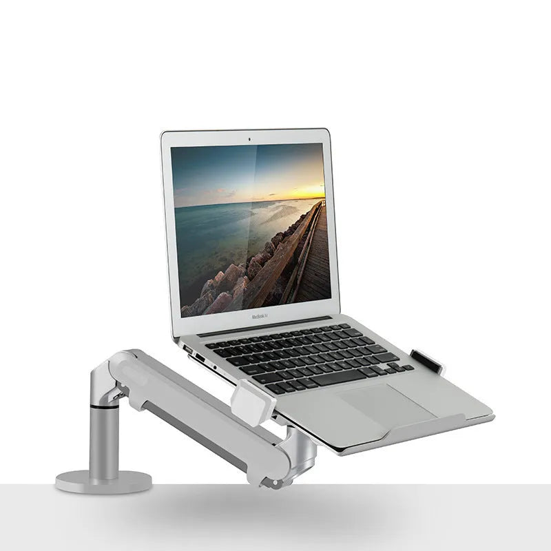 Silver aluminium hover arm laptop stand with adjustable height mechanism on wooden desk