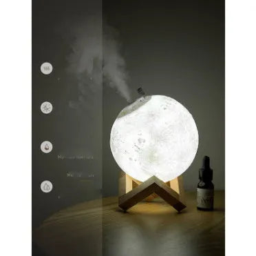 Wood coloured spherical Lunar humidifier night light on a bedside table emitting mist and soft white light.