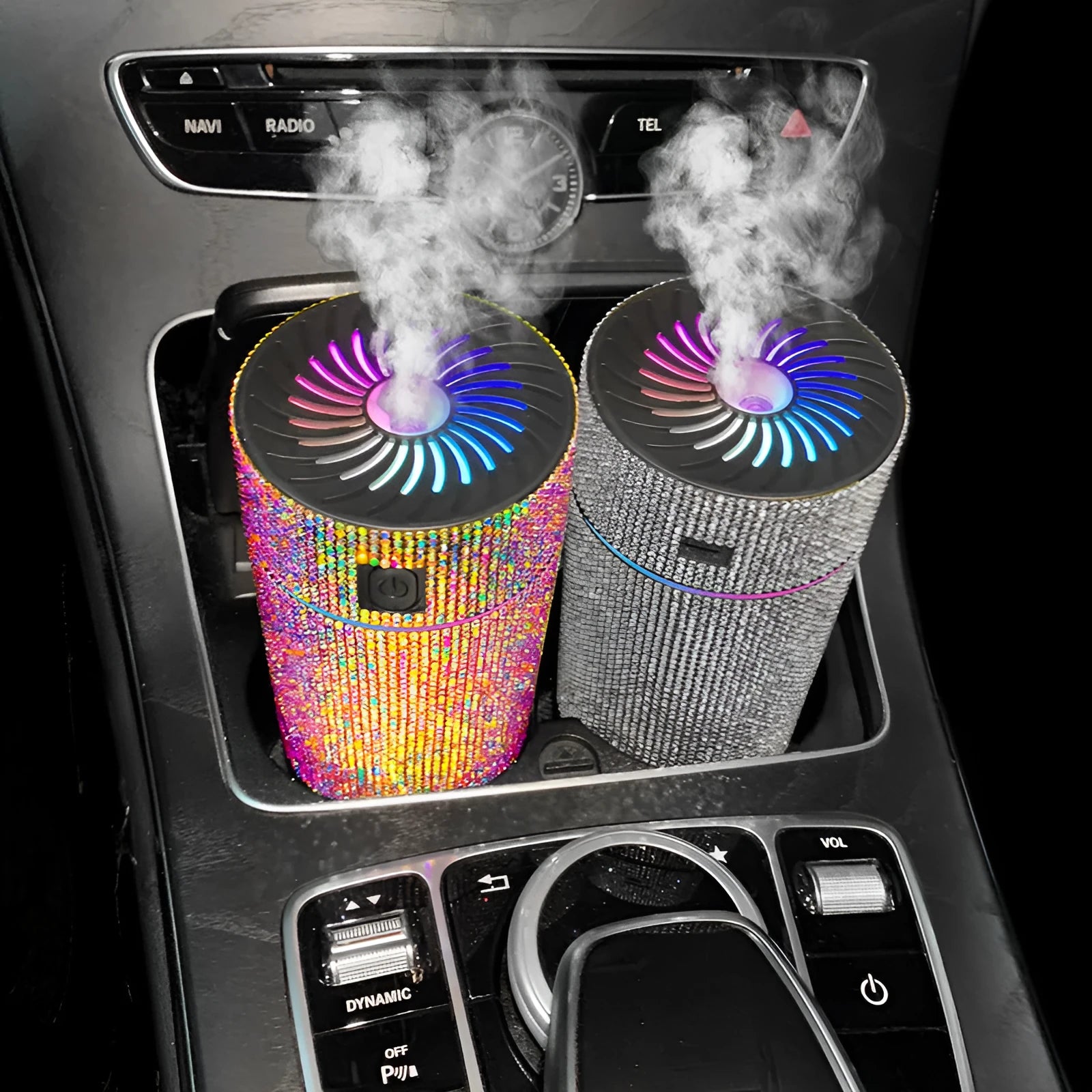 Compact white diamond car air purifier and humidifier unit with USB cable on a car dashboard.