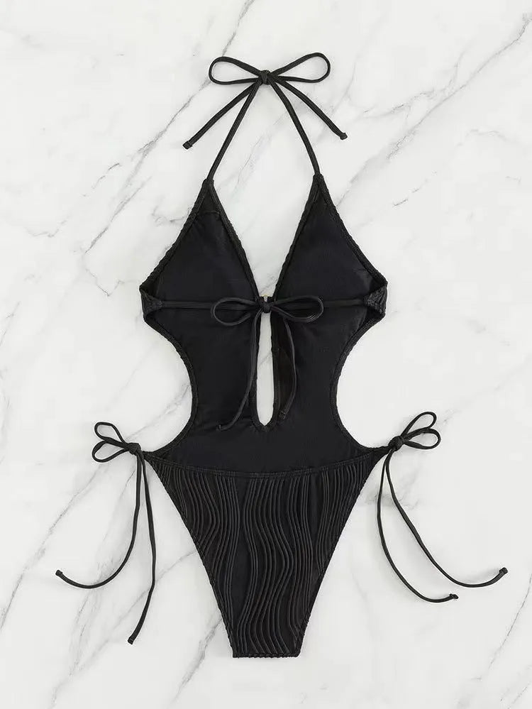Women's black triangle bikini swimsuit with lace-up front closure on mannequin