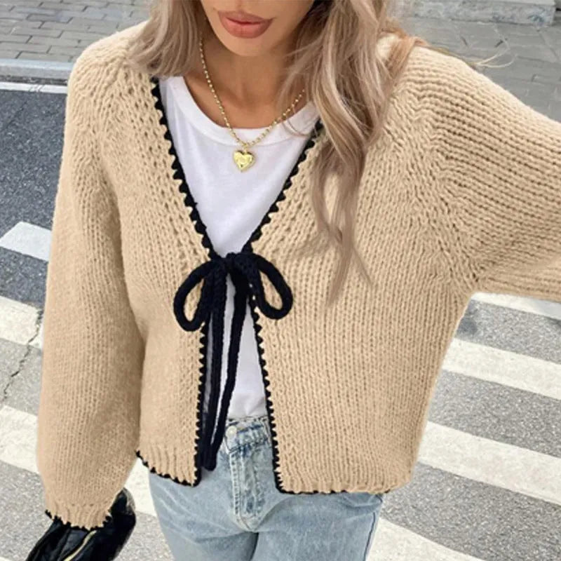 Women's gray loose-fit cardigan with long sleeves and white crochet flower details on the front.