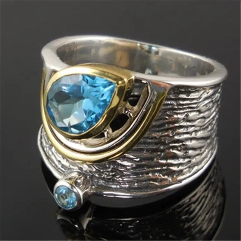 Blue zircon drop shape ring with Chinese-inspired design in alloy setting