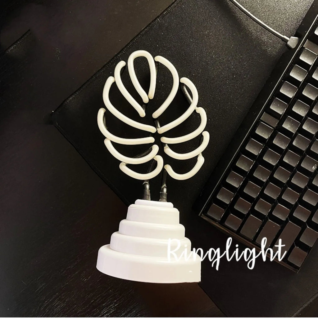 White bamboo-shaped desk lamp with green light, showing large and small size options.