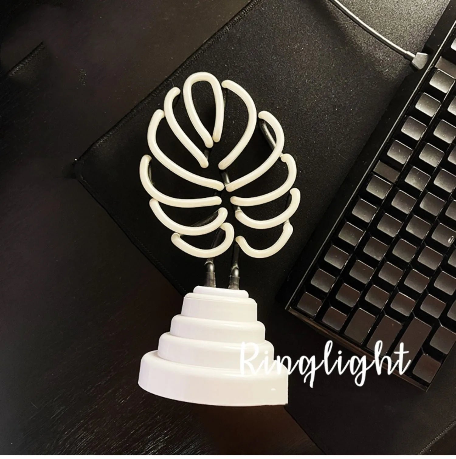 White bamboo-shaped desk lamp with green light, showing large and small size options.