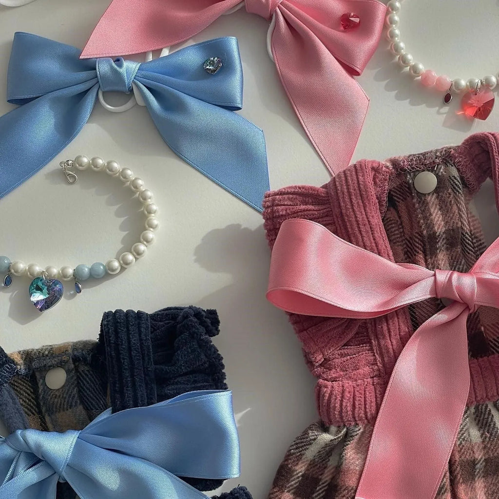 Blue princess-style bow dog hair band with adjustable tension on a model.