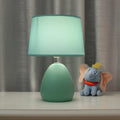 Small Nordic minimalist ceramic desk lamp in pink with LED light on desk