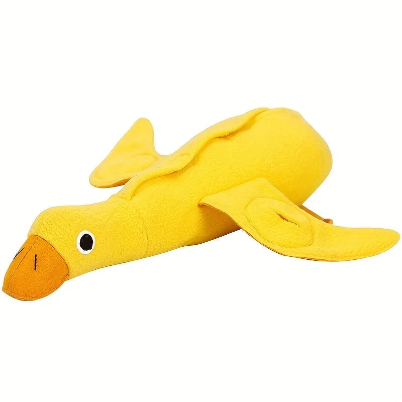 Yellow plush dog toy with attached rubber duck and a treat slot on a white background.