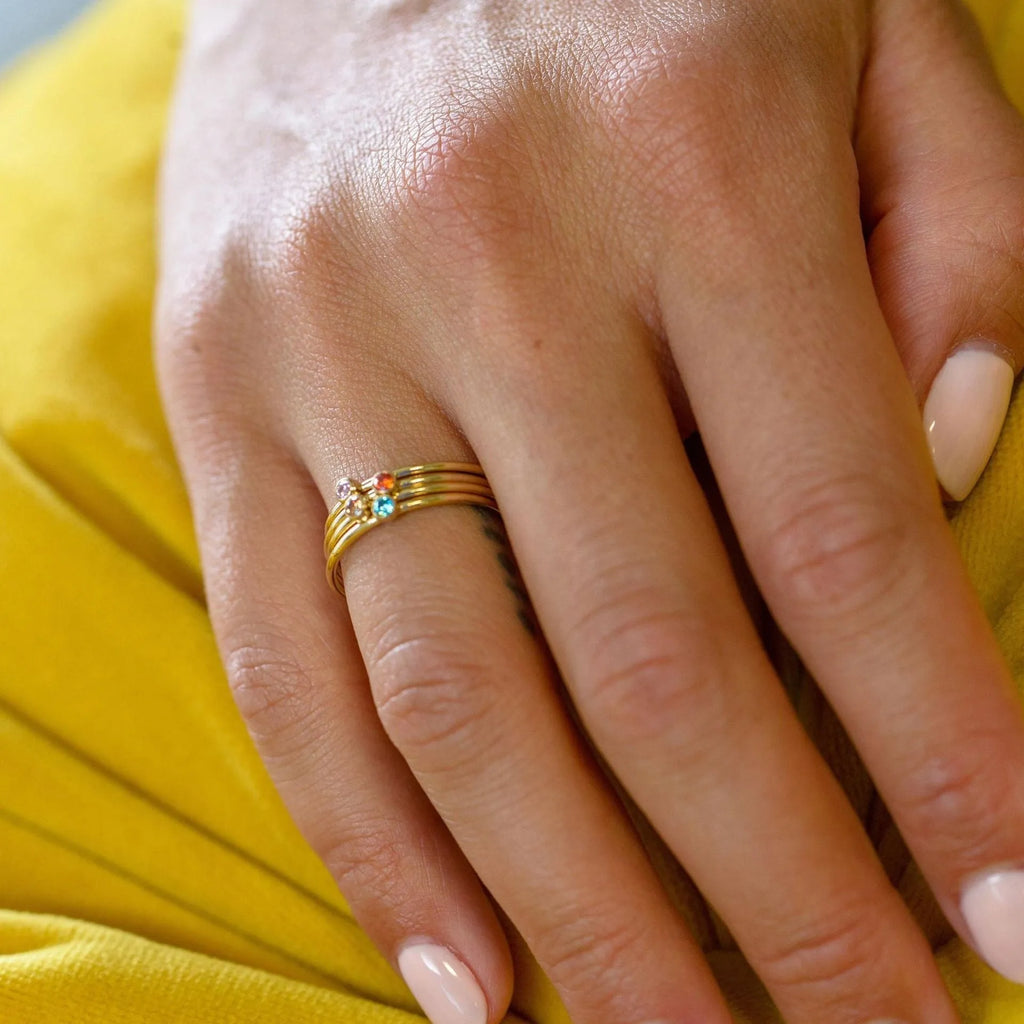 A geometric engraved titanium steel ring featuring a December birthstone colour.