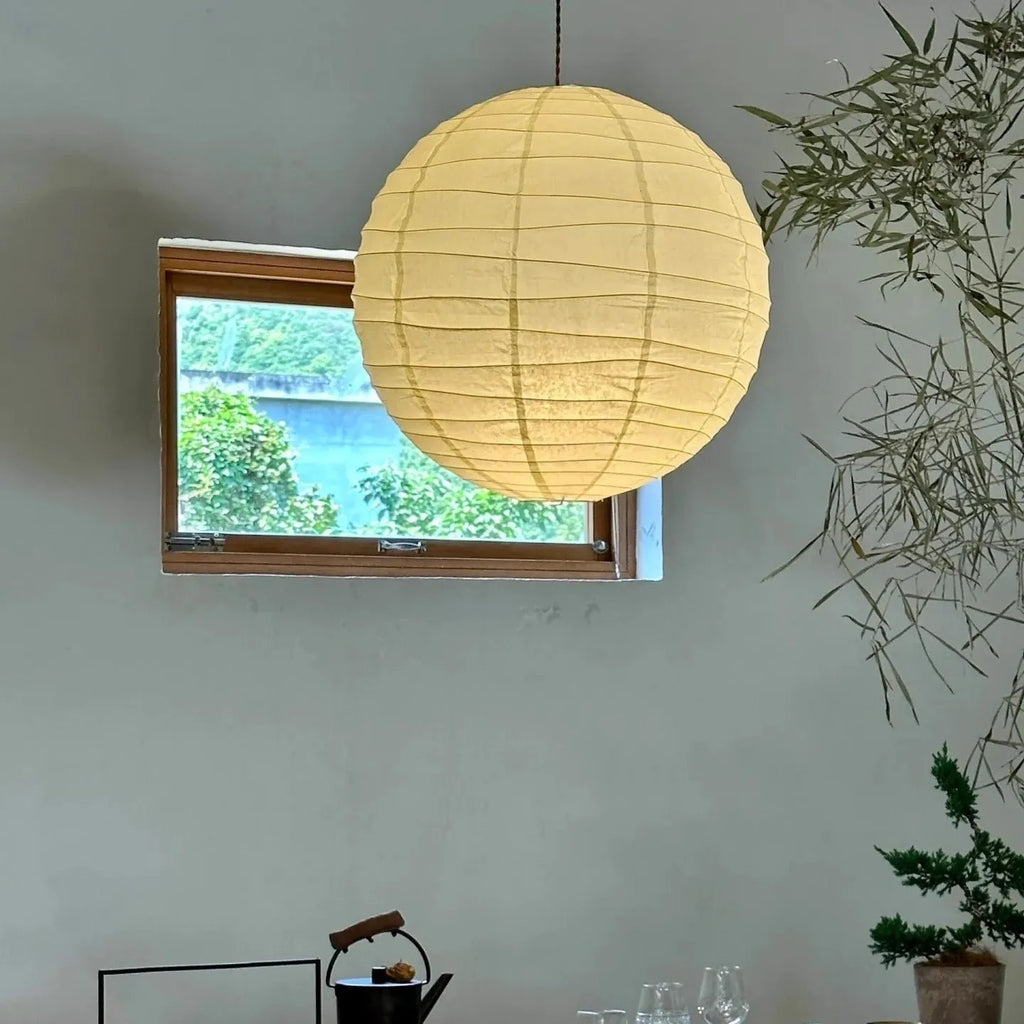 Japanese style spherical rice paper ball chandelier pendant light with warm glow.