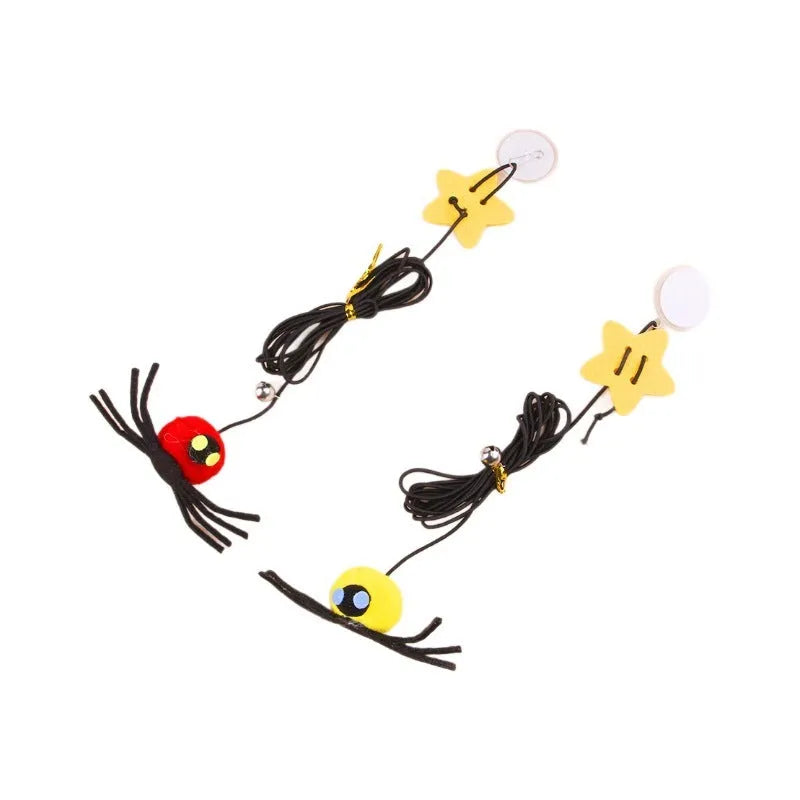 Red and yellow hanging cat toy with elastic rope, feathers, and a bell spider attached to a door.