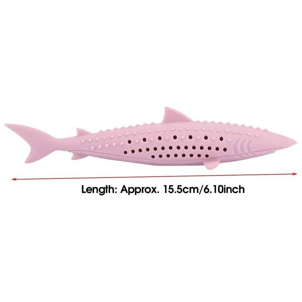 Green silicone dolphin-shaped cat chew toy on a white background, showing side air holes.