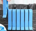 Grey PP plastic garbage bag fixing clip attached to bin side holding liner securely