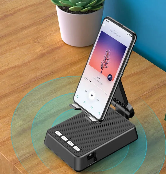 Black mobile phone broadcaster stand with Bluetooth speaker and microphone on desk