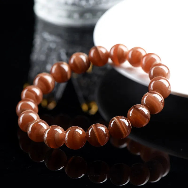 Natural Old Mine Rhodochrosite round beads bracelet from Peru showing manganese spar mineral colour