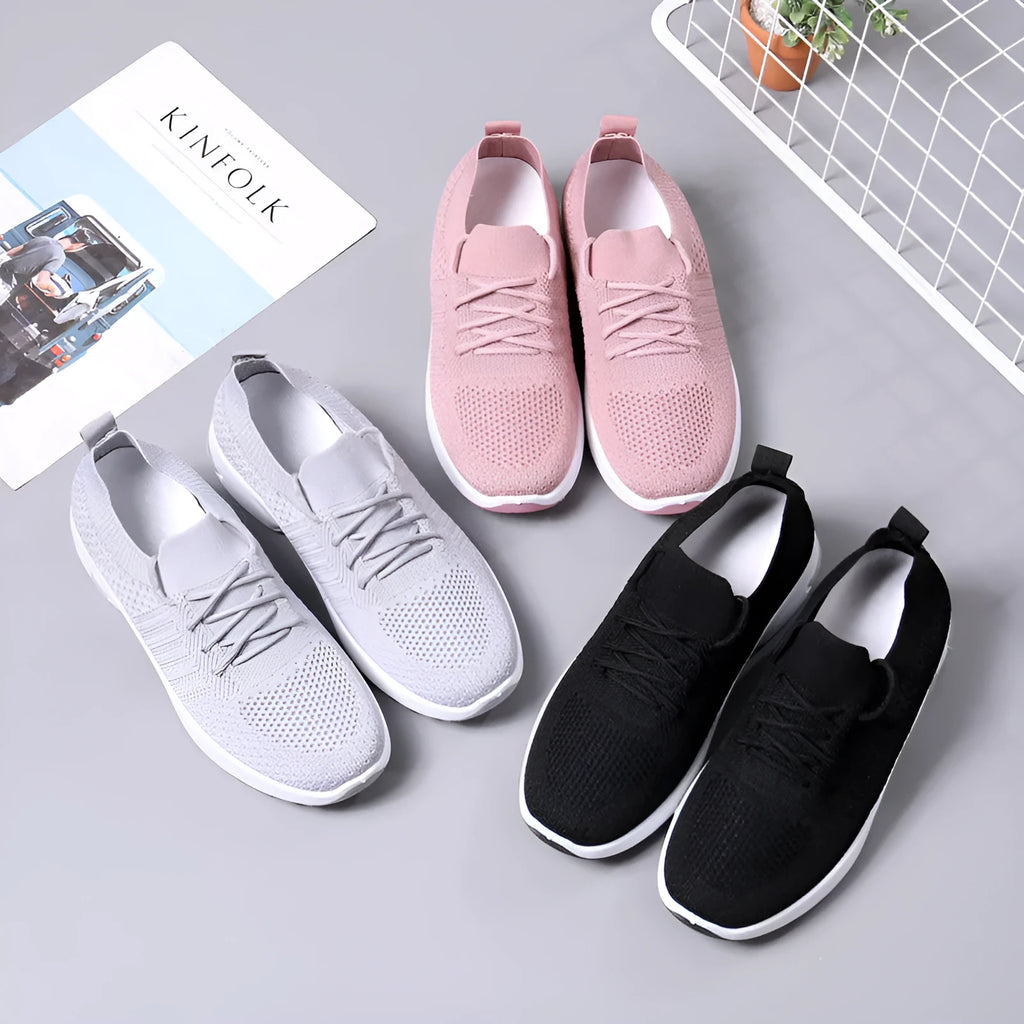 Women's black mesh casual sneakers with round toe and white non-slip PVC sole on a light background.