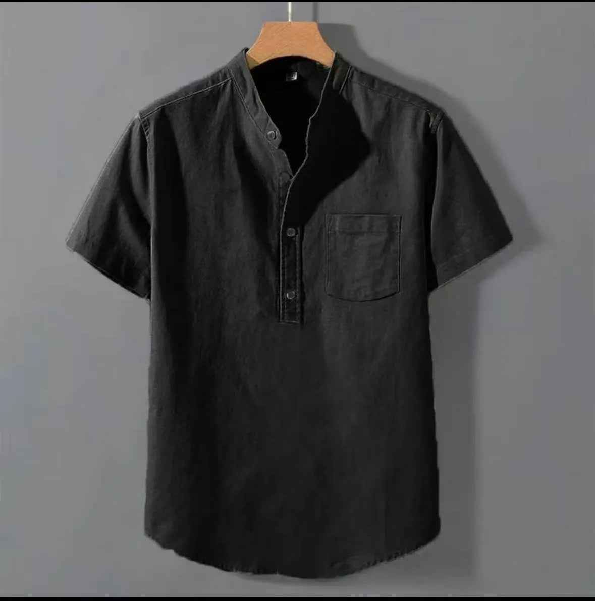 Men's loose-fit solid colour linen shirt with a stand collar and short sleeves on a hanger.