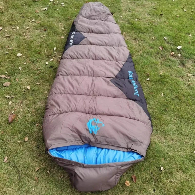 Cotton-filled camping sleeping bag in army green with its grey compression storage bag.