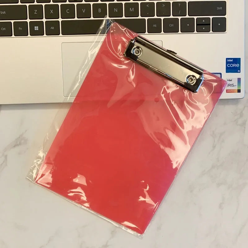 Transparent A4 writing board pad with metal clip holding documents, available in blue, green, red, and white colours