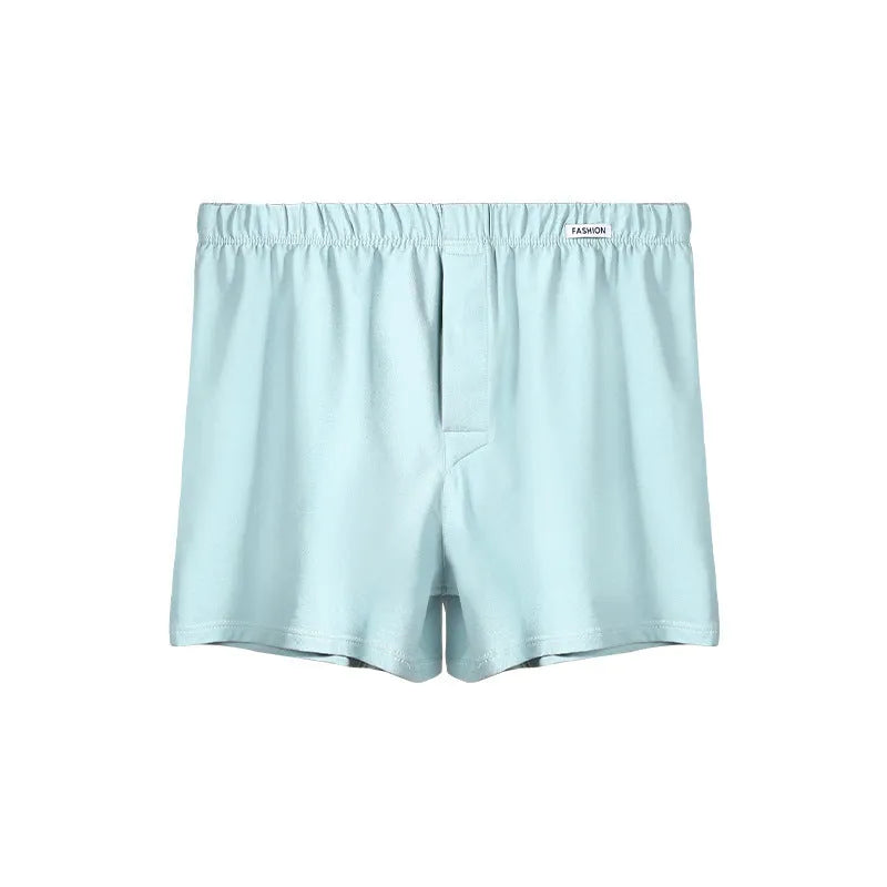 Men's loose-fitting cotton boxer shorts in solid colours on a hanger