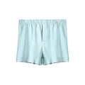 Men's loose-fitting cotton boxer shorts in solid colours on a hanger