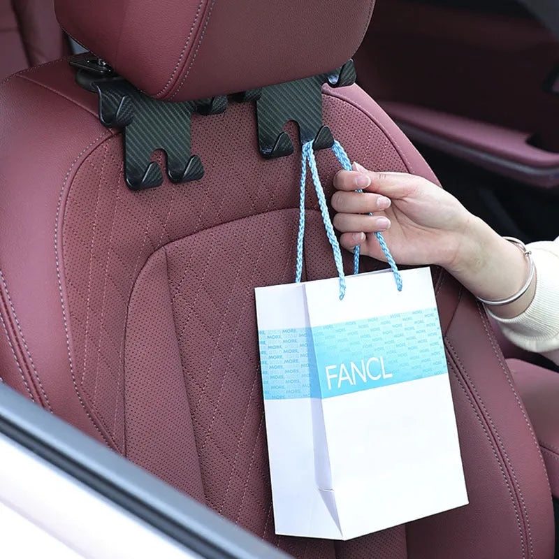 Black ABS plastic car hook with an integrated mobile phone holder bracket for rear seat organisation.