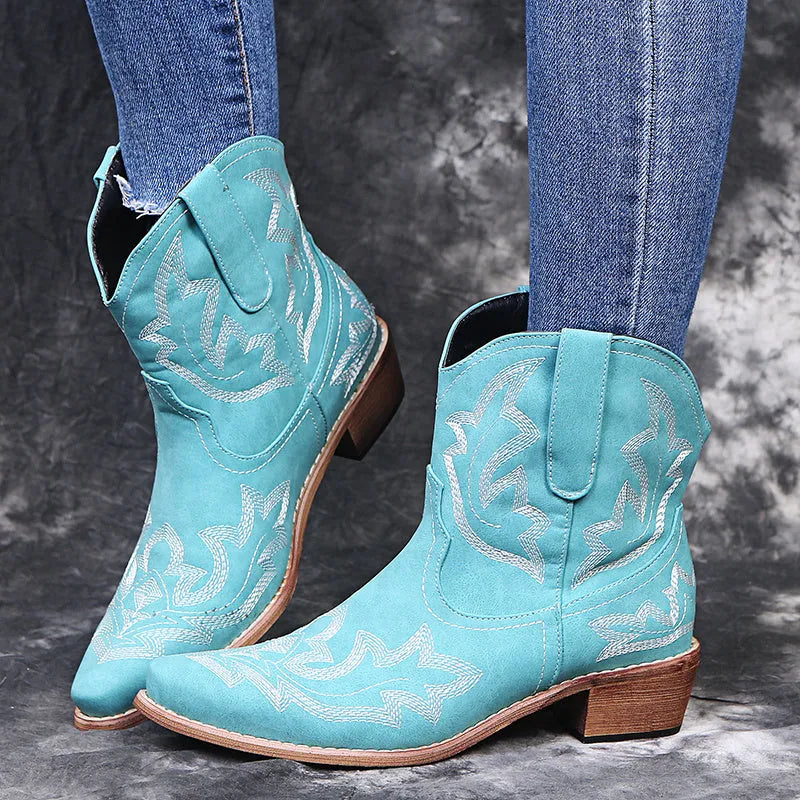 Women's blue embroidered cowboy ankle boots with a low wedge heel and pointed toe.