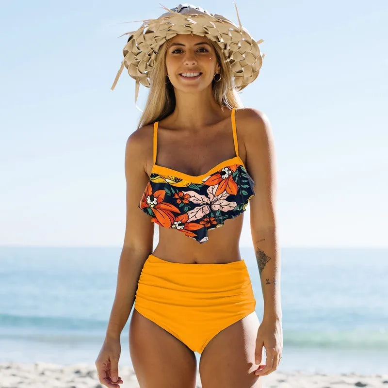 Blue floral print women's bikini swimsuit with high-waisted pleated pants on a mannequin.