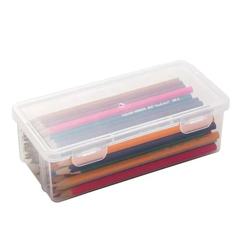 Transparent plastic stationery storage box containing pencils and drawing supplies
