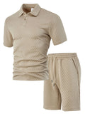 Man wearing a light grey thin figured cloth short sleeve polo shirt and trousers from a casual suit set.