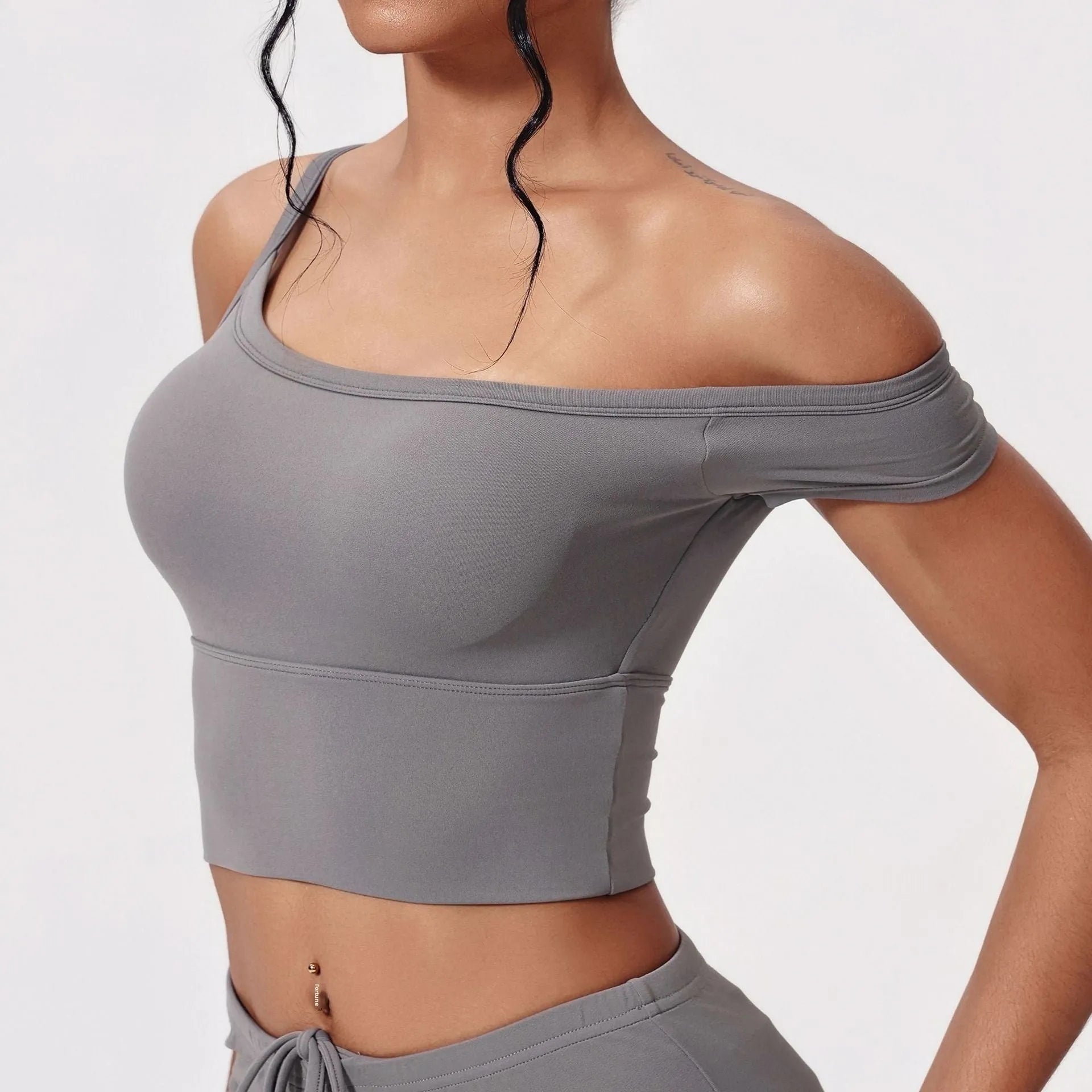 Asymmetric padded yoga vest in white with wireless full cup design and fixed double straps for women