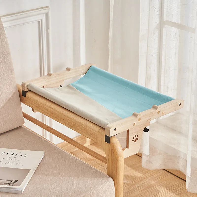 Wooden frame cat hanging bed with fabric hammock mounted by a window