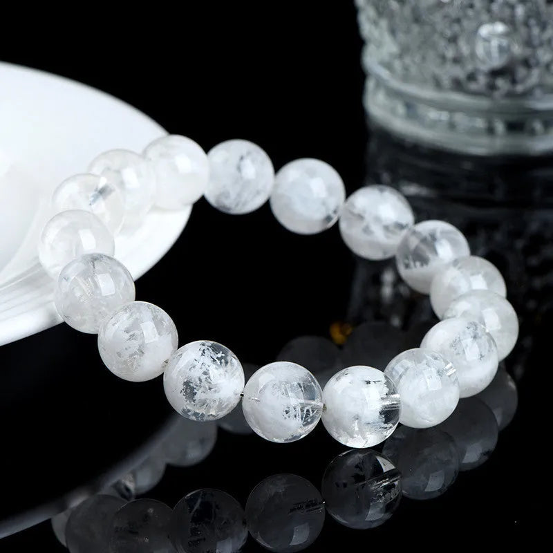 Natural blizzard snowflake crystal bracelet with round beads showing Ruyi and Xiangyun design elements